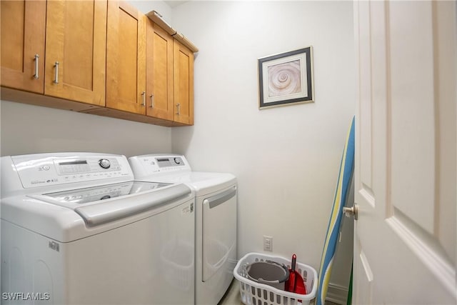 laundry room featuring cabinet space and independent washer and dryer