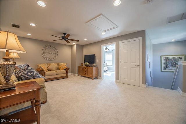 carpeted living area with attic access, recessed lighting, visible vents, and baseboards