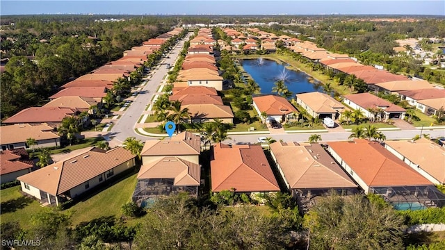 drone / aerial view featuring a residential view and a water view