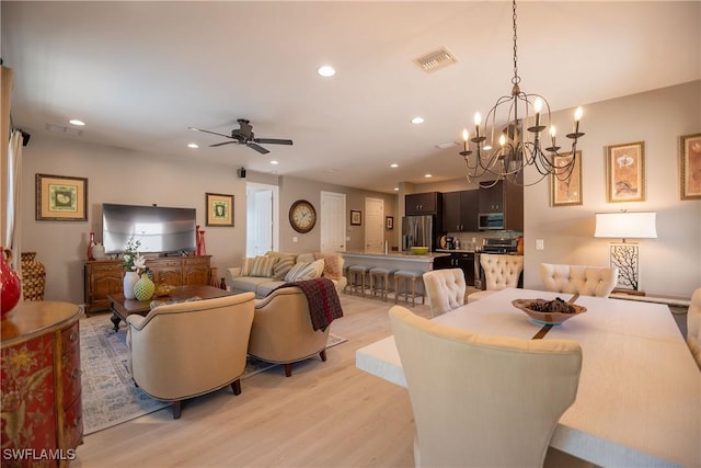 dining area featuring light wood-style floors, recessed lighting, visible vents, and a ceiling fan