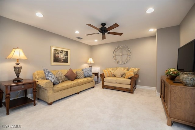 living area with a ceiling fan, recessed lighting, light colored carpet, and visible vents