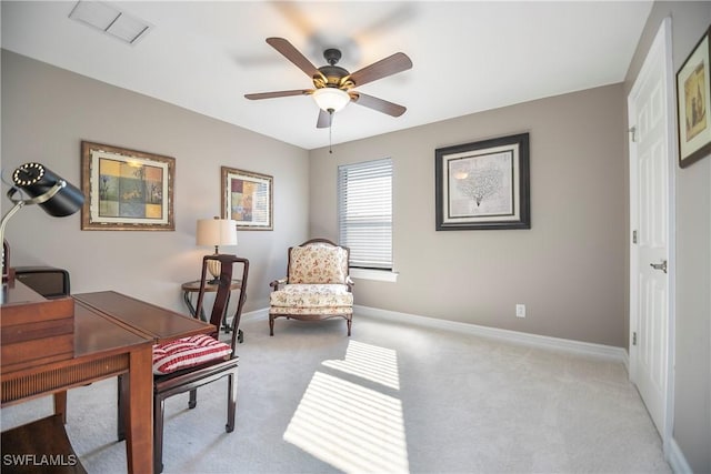 office area featuring a ceiling fan, light carpet, visible vents, and baseboards