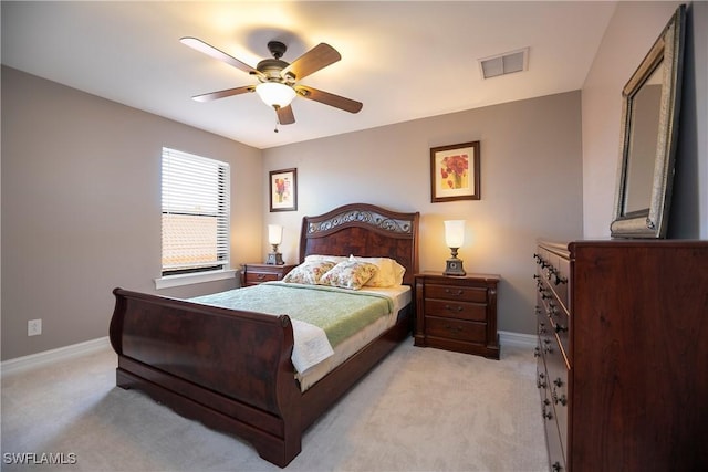 bedroom featuring baseboards, ceiling fan, visible vents, and light colored carpet