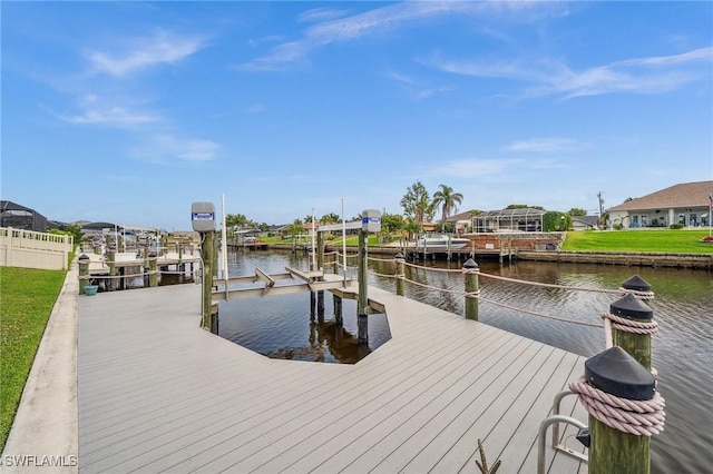 view of dock with a residential view, a water view, and boat lift