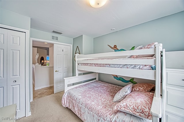 bedroom with light carpet, visible vents, and baseboards