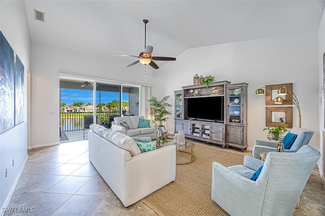 living room with light tile patterned floors, visible vents, a ceiling fan, vaulted ceiling, and baseboards