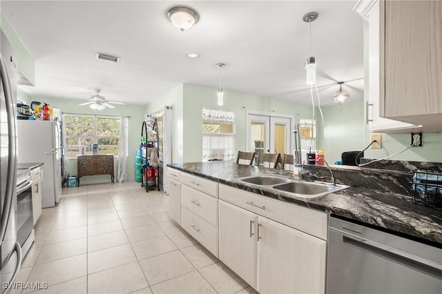 kitchen with light tile patterned floors, a sink, visible vents, french doors, and dishwasher