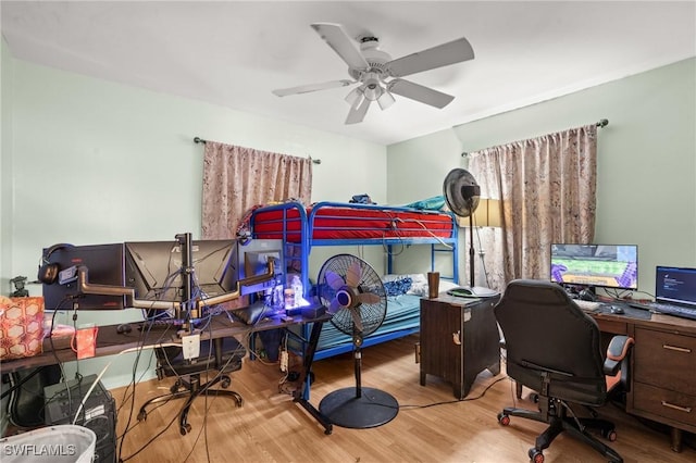 bedroom with ceiling fan and wood finished floors