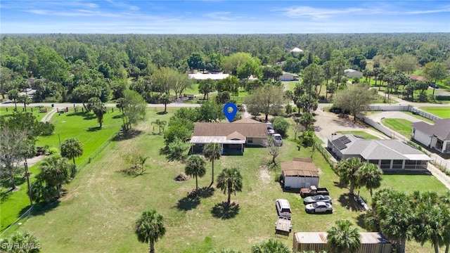 birds eye view of property with a view of trees