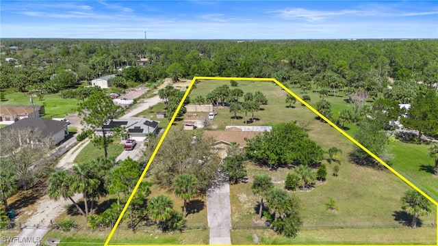 birds eye view of property featuring a wooded view