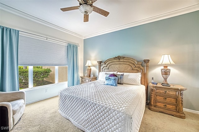 carpeted bedroom with crown molding, baseboards, and a ceiling fan