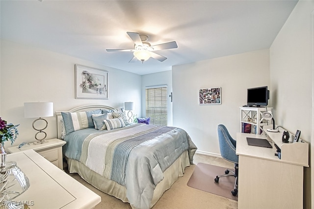 bedroom with light carpet and a ceiling fan