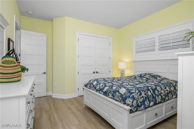 bedroom featuring light hardwood / wood-style flooring and a closet