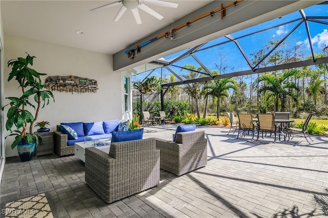 view of patio / terrace featuring an outdoor living space, ceiling fan, and a lanai