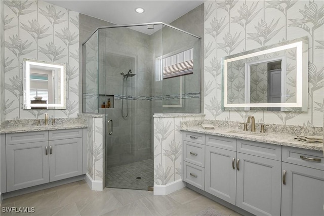 bathroom featuring vanity and a shower with shower door