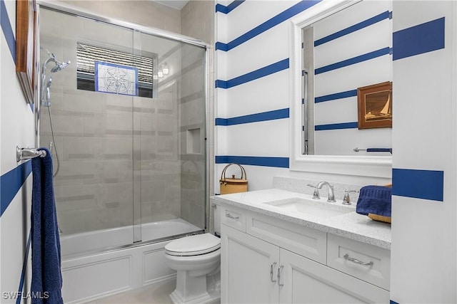 full bathroom with toilet, shower / bath combination with glass door, and vanity