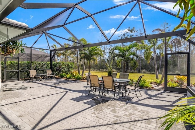 view of patio / terrace featuring glass enclosure