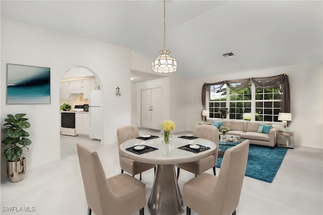 dining space with vaulted ceiling