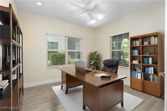 office space with a healthy amount of sunlight and ceiling fan