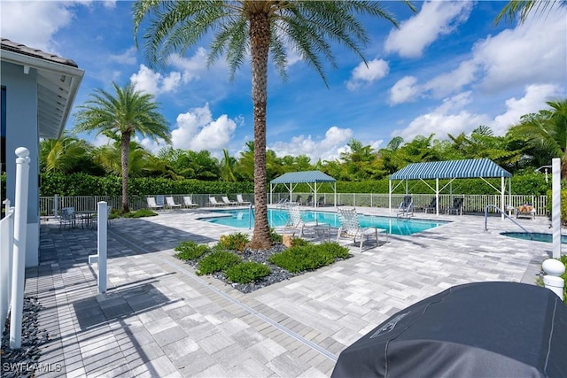 view of swimming pool with a patio and area for grilling