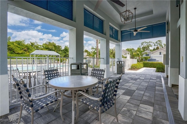 view of patio / terrace featuring a fenced in pool and ceiling fan