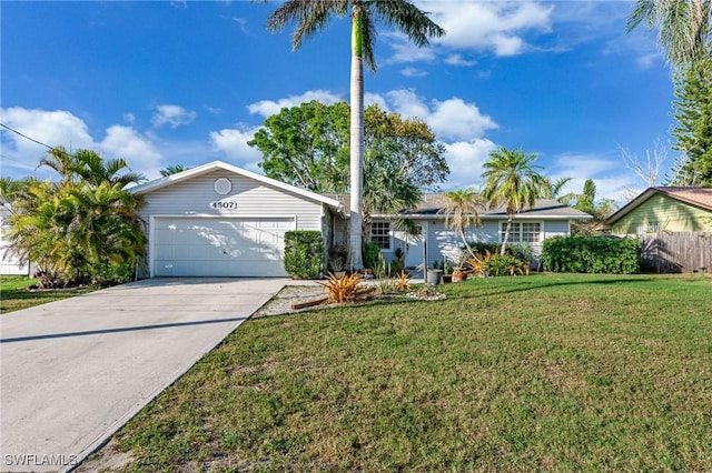 ranch-style home with a garage, driveway, and a front yard