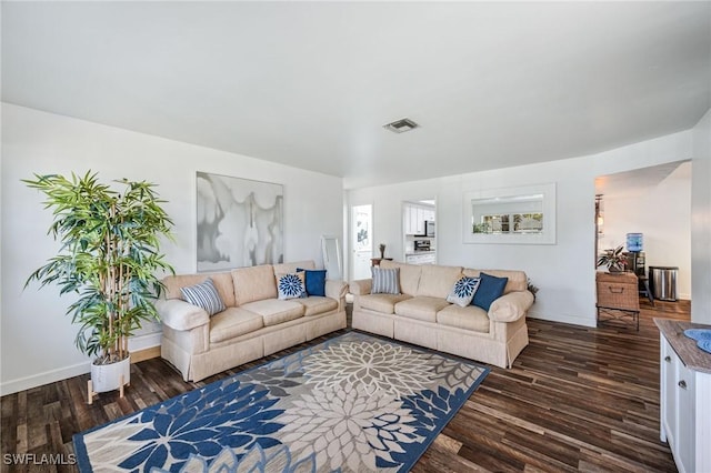 living area with dark wood-style floors, baseboards, and visible vents