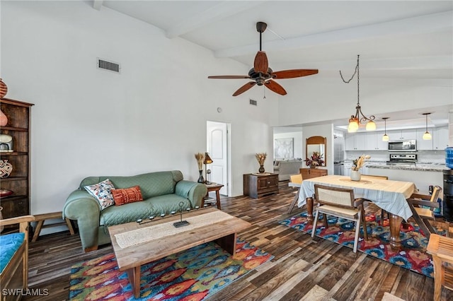 living area with arched walkways, visible vents, a ceiling fan, dark wood finished floors, and beam ceiling