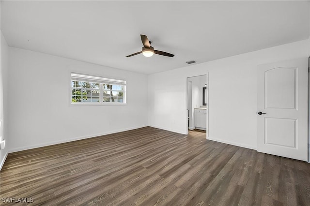 unfurnished bedroom featuring a ceiling fan, dark wood-style flooring, visible vents, and baseboards