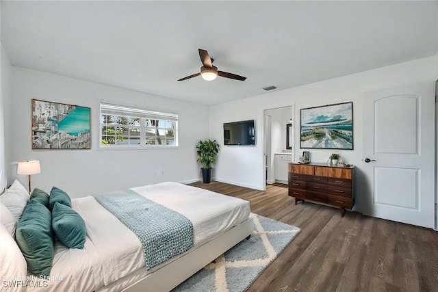 bedroom featuring baseboards, dark wood-type flooring, visible vents, and a ceiling fan