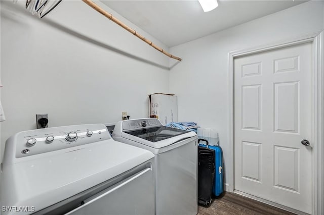 laundry area with laundry area, dark wood finished floors, and washer and clothes dryer