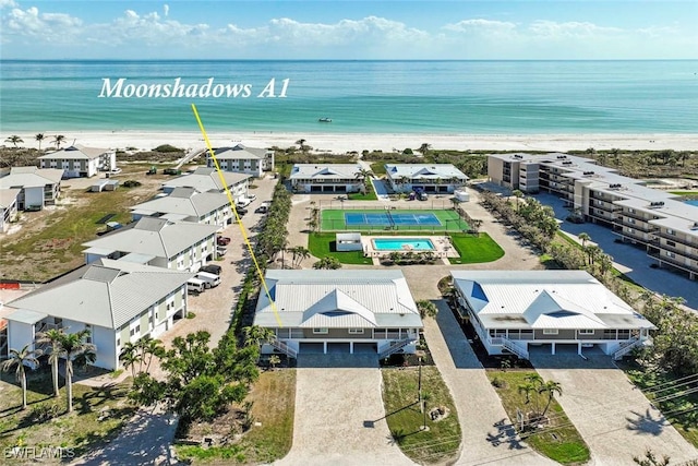 bird's eye view featuring a water view and a view of the beach