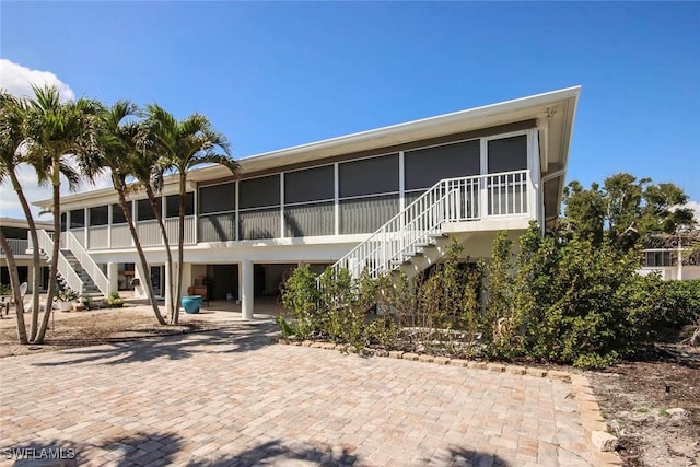 back of house featuring a sunroom