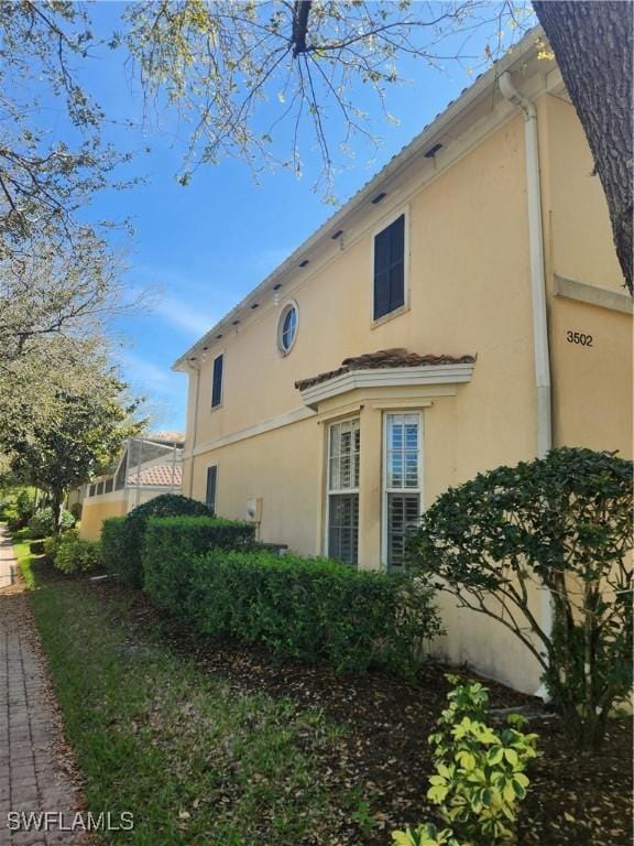 view of side of property with stucco siding