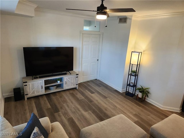 living area with crown molding, baseboards, a ceiling fan, and dark wood-type flooring