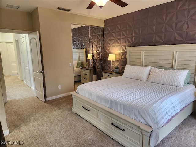 bedroom featuring light colored carpet, ceiling fan, and baseboards
