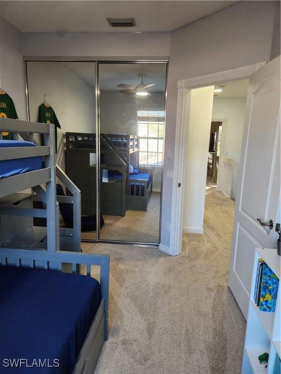 bedroom with carpet and a closet