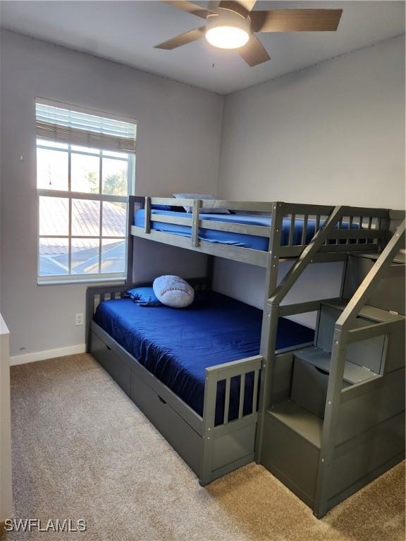 bedroom with carpet flooring, baseboards, and ceiling fan