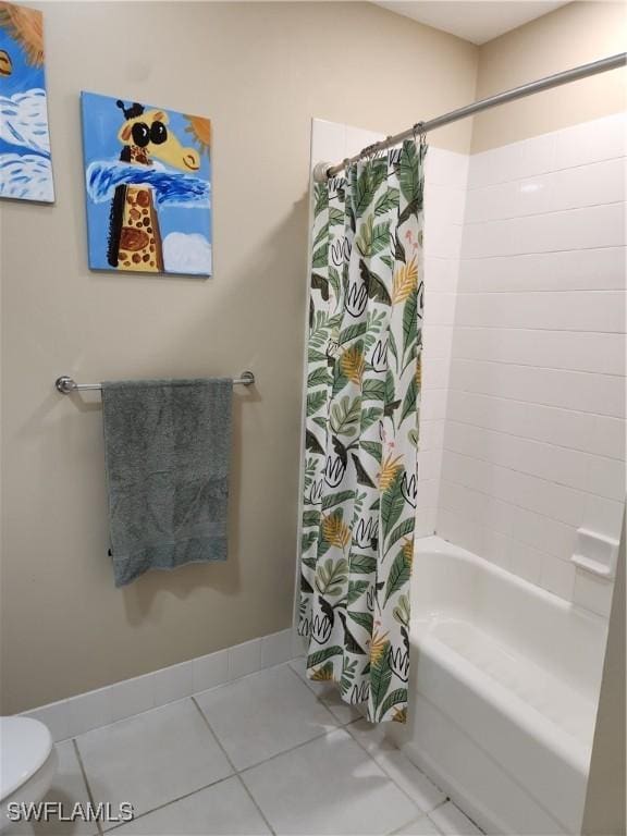full bath with tile patterned floors, shower / tub combo with curtain, and toilet