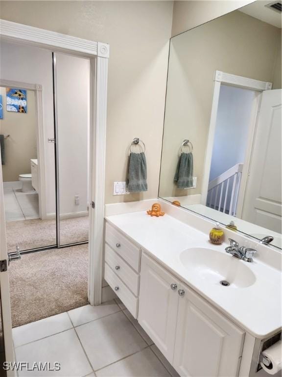 bathroom with vanity, toilet, and tile patterned flooring
