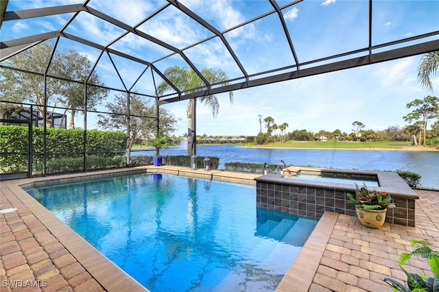 outdoor pool with a lanai, a water view, a patio area, and an in ground hot tub