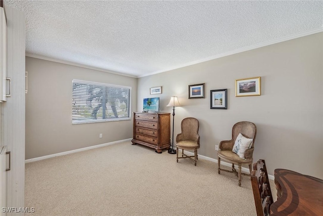 living area featuring a textured ceiling, ornamental molding, baseboards, and light carpet