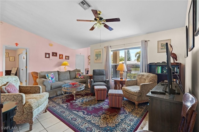 living area featuring visible vents, light tile patterned flooring, a ceiling fan, and vaulted ceiling