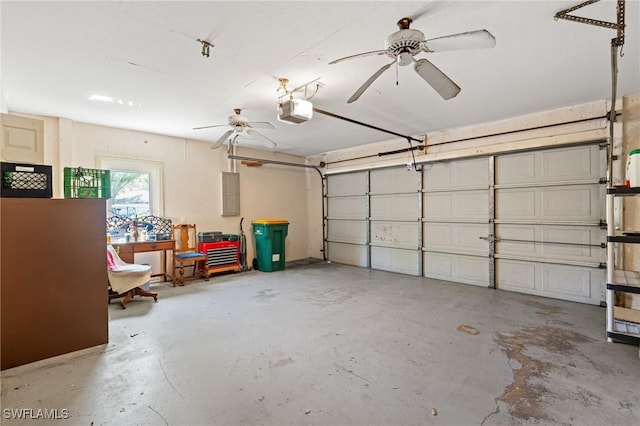 garage featuring electric panel, a garage door opener, and a ceiling fan