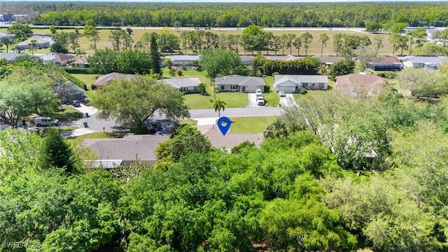 aerial view featuring a wooded view and a residential view