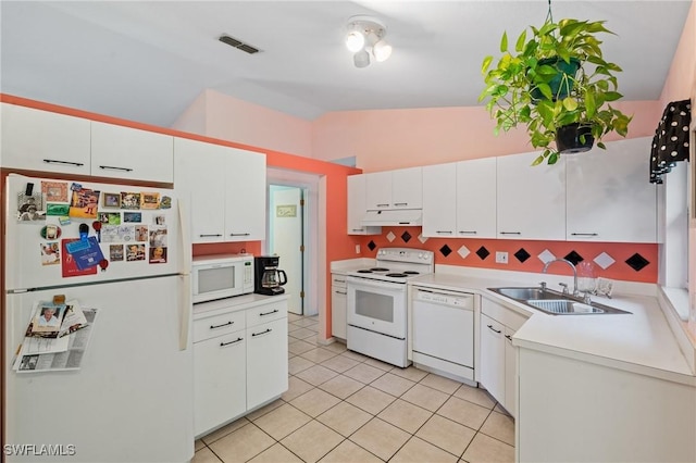 kitchen with white appliances, visible vents, lofted ceiling, a sink, and under cabinet range hood