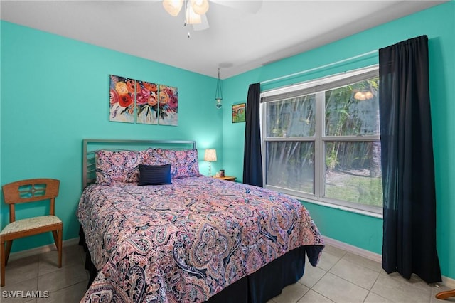 tiled bedroom featuring baseboards and ceiling fan