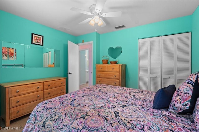 bedroom featuring a closet, visible vents, tile patterned floors, and ceiling fan