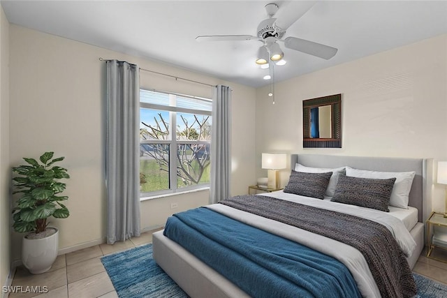 bedroom with light tile patterned floors, baseboards, and ceiling fan