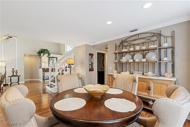 dining area with light wood-type flooring and crown molding